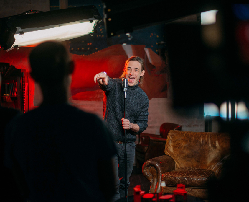 Front View Of A Comedian Doing Crowd Work At A Comedy Show