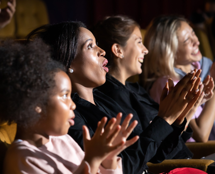 Side View Of A Group Of Women Cheering