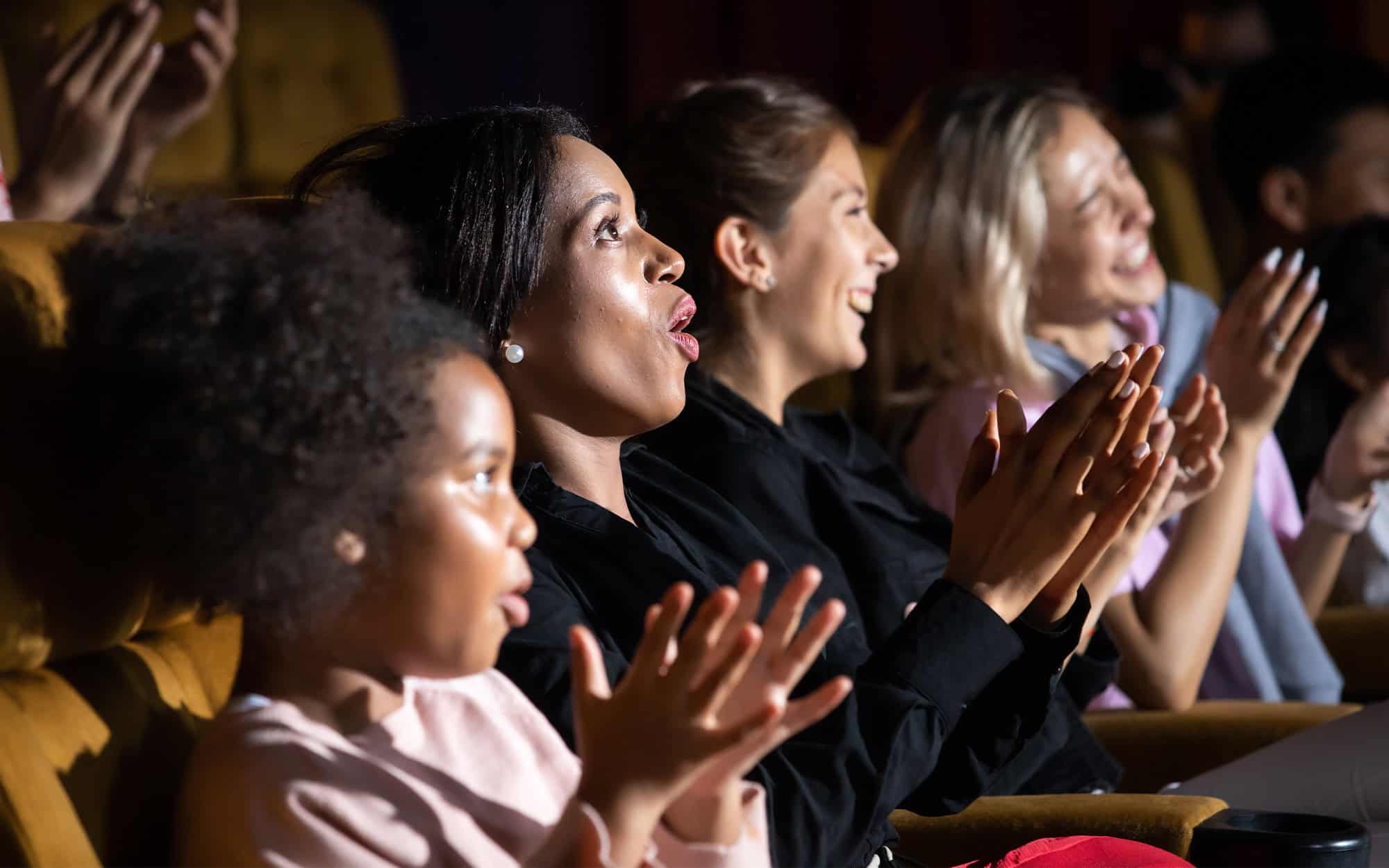 Side View Of A Group Of Women Cheering