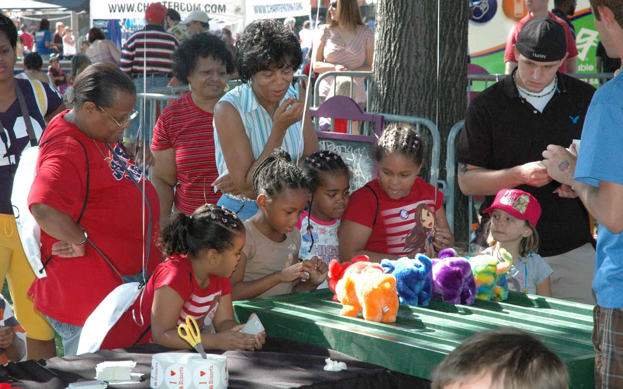 Side View Of Kids Playing With Carnival Toys